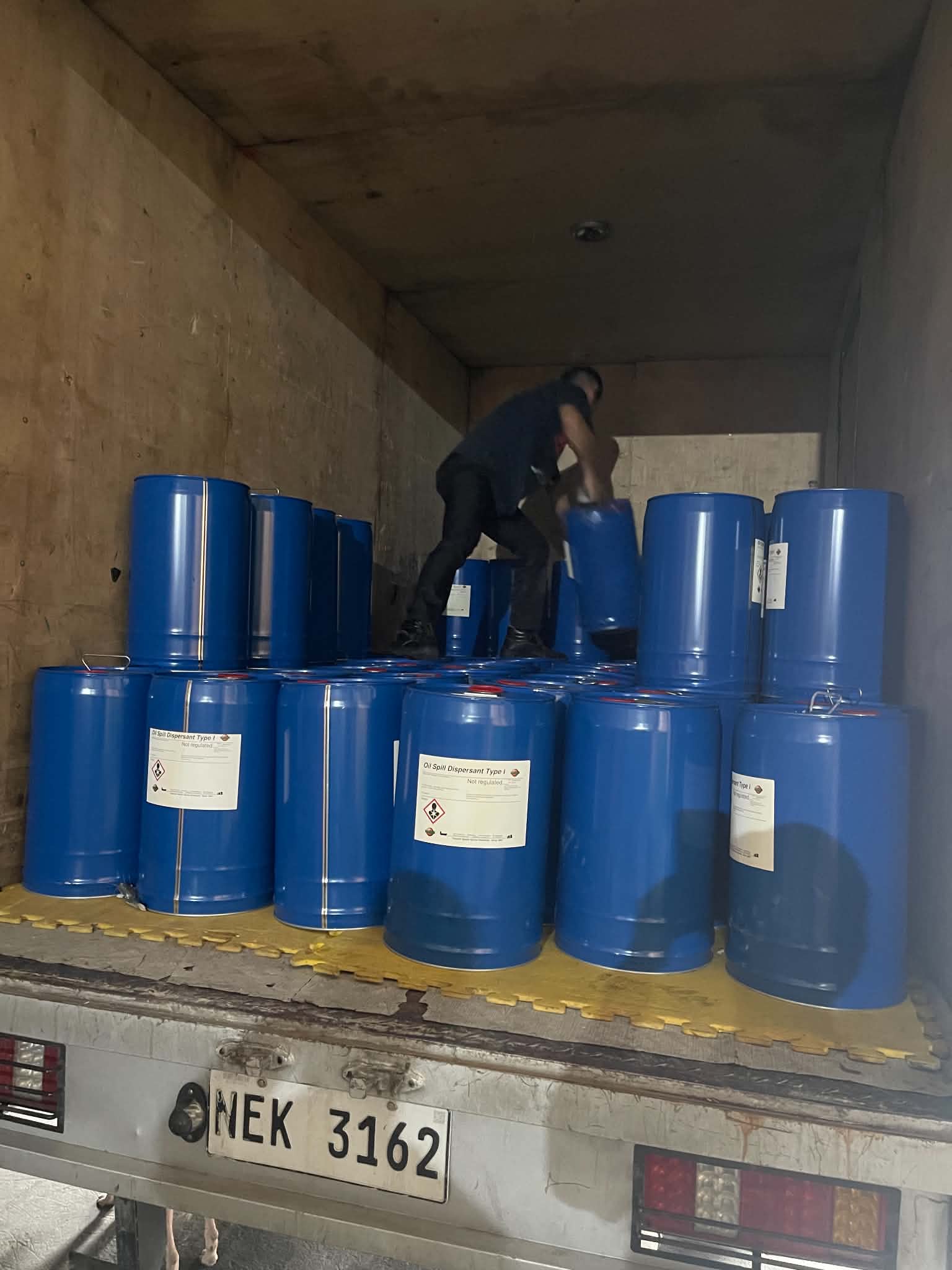 Product jerry cans being loaded onto a delivery boat at a Manila port