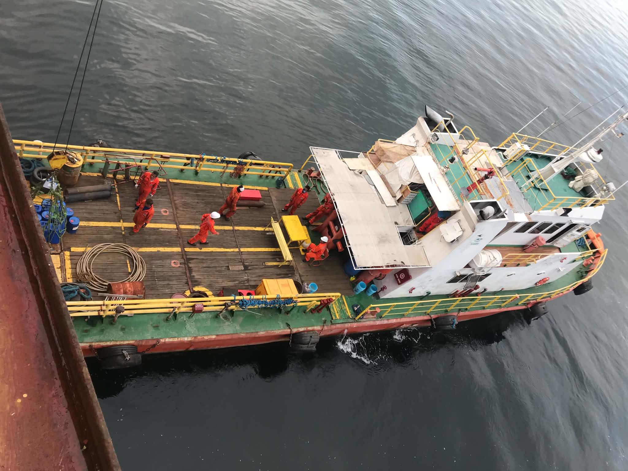 Crew on deck of a workboat during delivery operations
