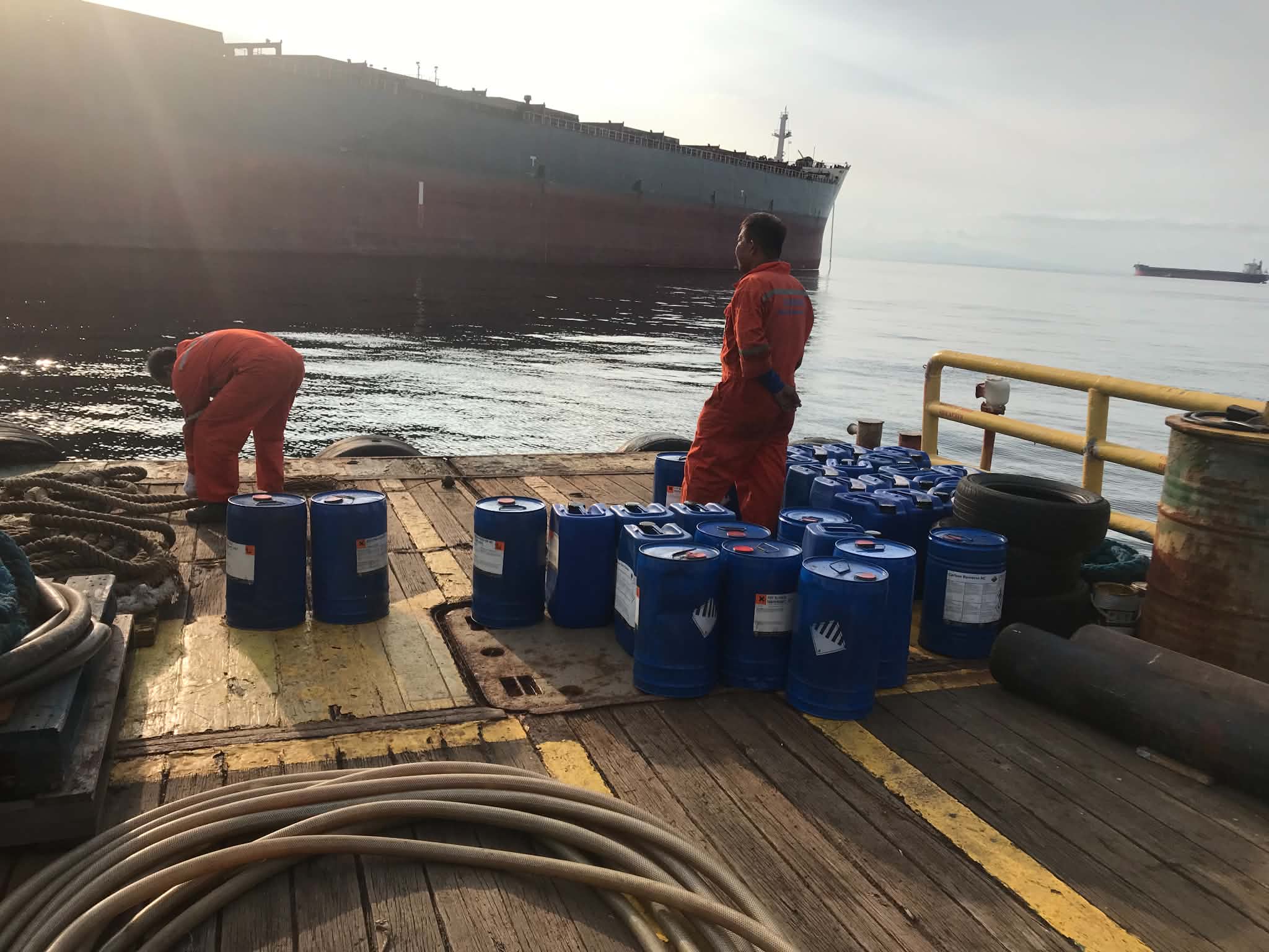 Crew preparing a delivery alongside a bulk carrier
